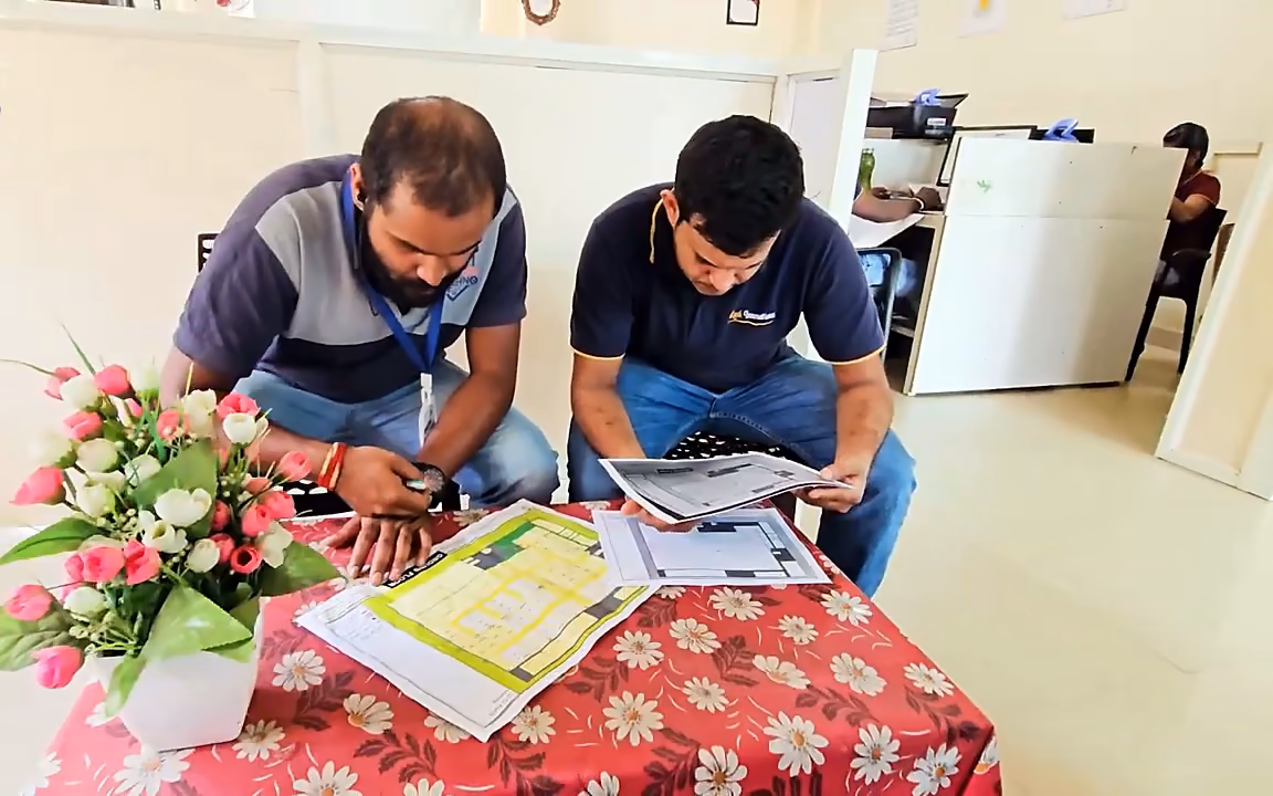 Yendra engineer and client reviewing a factory CCTV layout drawing